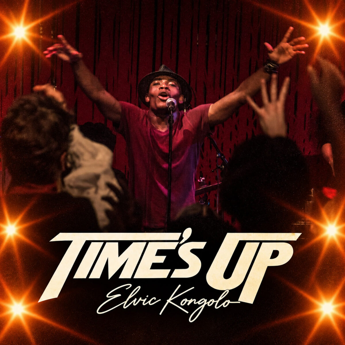 Cover art for Time's Up: Elvic Kongolo on stage with arms raised, crowd in front, stage lights around the edges