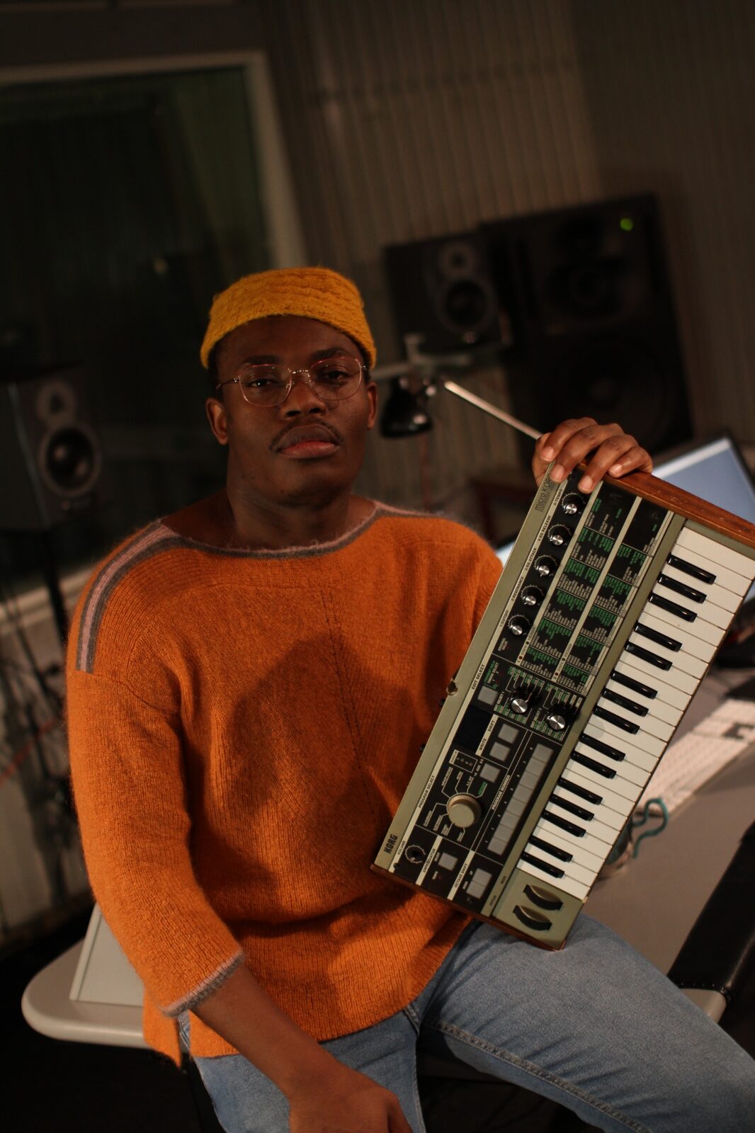 Elvic Kongolo in the studio in Oslo holding a synthesizer
